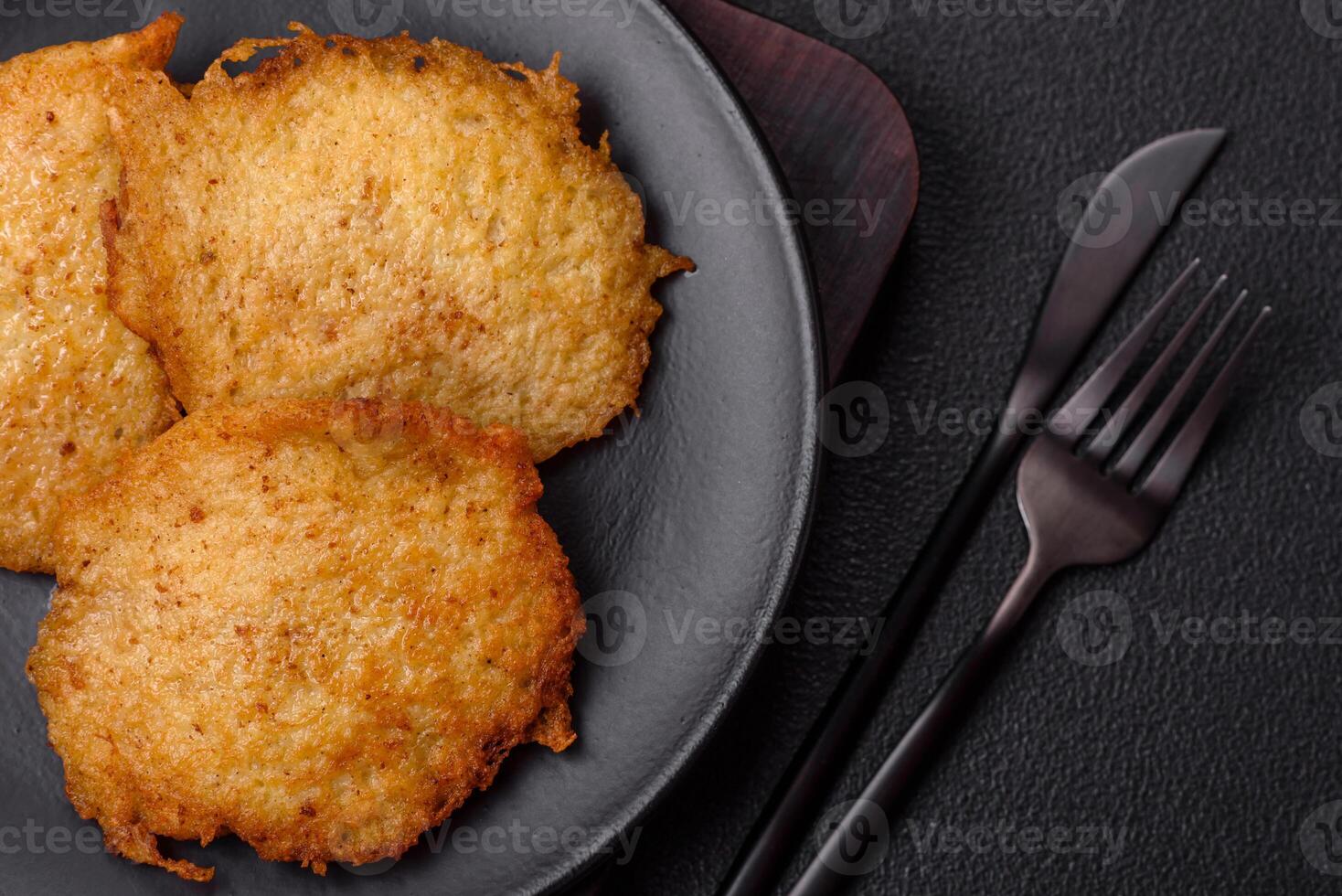 Delicious crispy pancakes made from potatoes, meat, carrots, onions photo