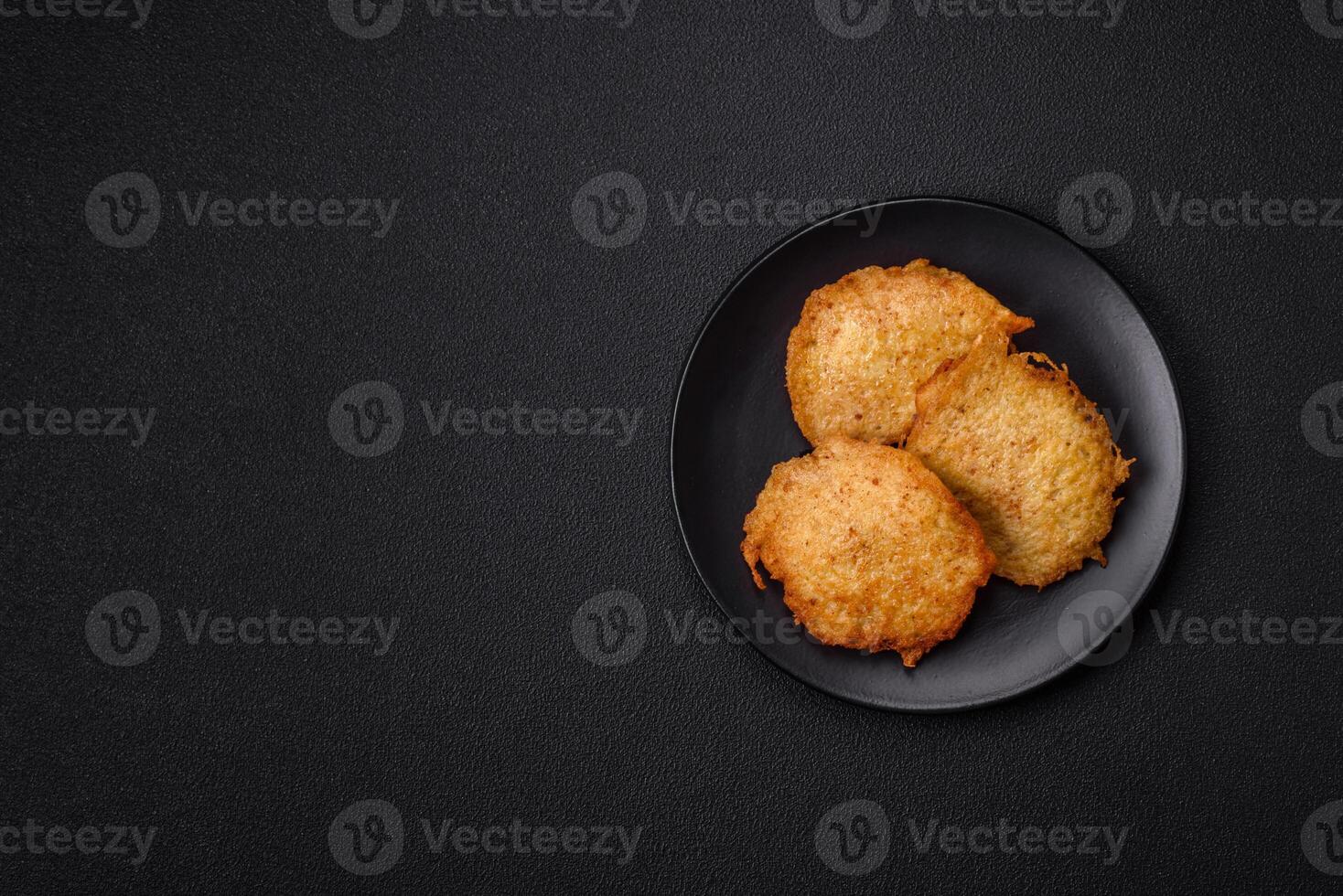 Delicious crispy pancakes made from potatoes, meat, carrots, onions photo
