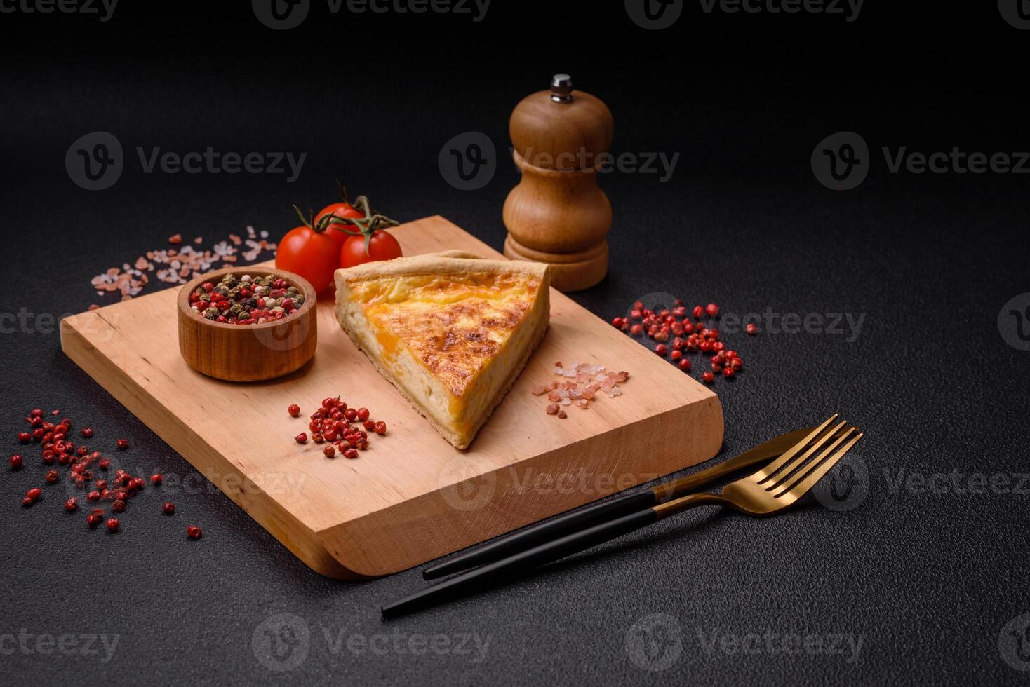 Delicious crispy quiche cut into slices with cheese, broccoli, tomatoes photo