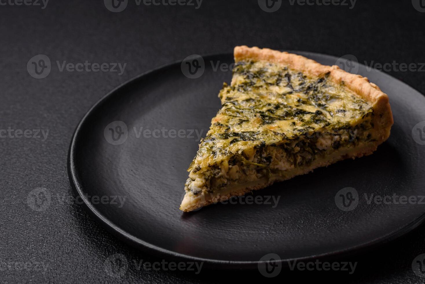 Delicious crispy quiche cut into slices with cheese, broccoli, tomatoes photo