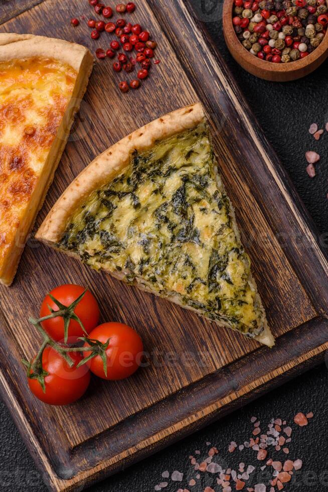 Delicious crispy quiche cut into slices with cheese, broccoli, tomatoes photo