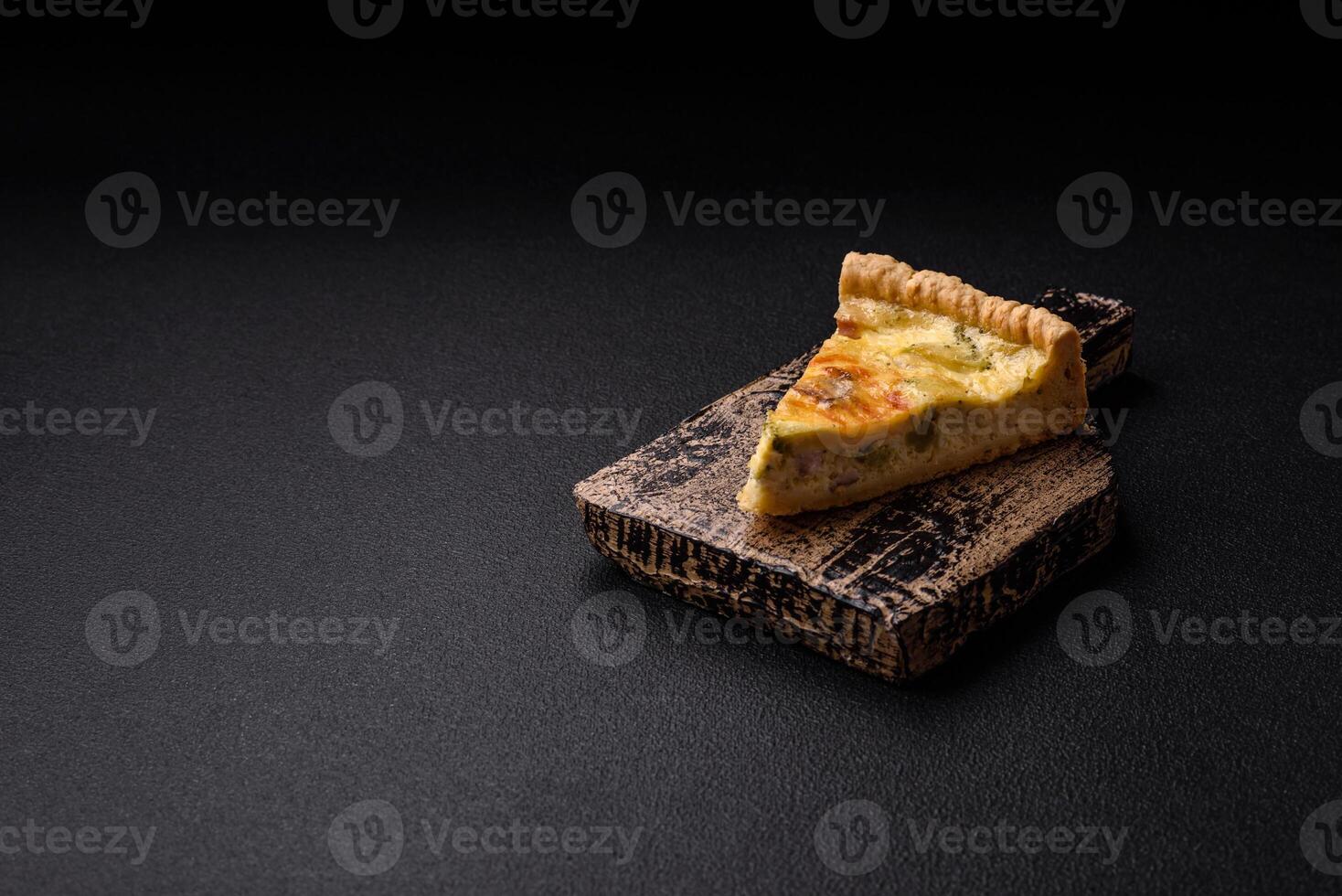 Delicious crispy quiche cut into slices with cheese, broccoli, tomatoes photo