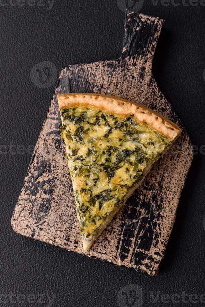 Delicious crispy quiche cut into slices with cheese, broccoli, tomatoes photo