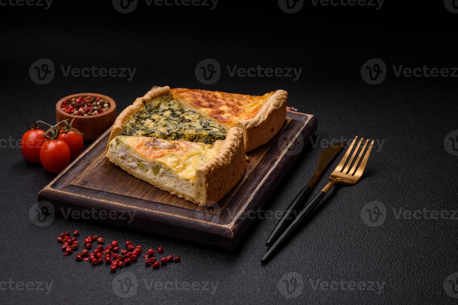 Delicious crispy quiche cut into slices with cheese, broccoli, tomatoes photo