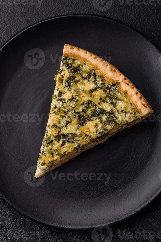 Delicious crispy quiche cut into slices with cheese, broccoli, tomatoes photo