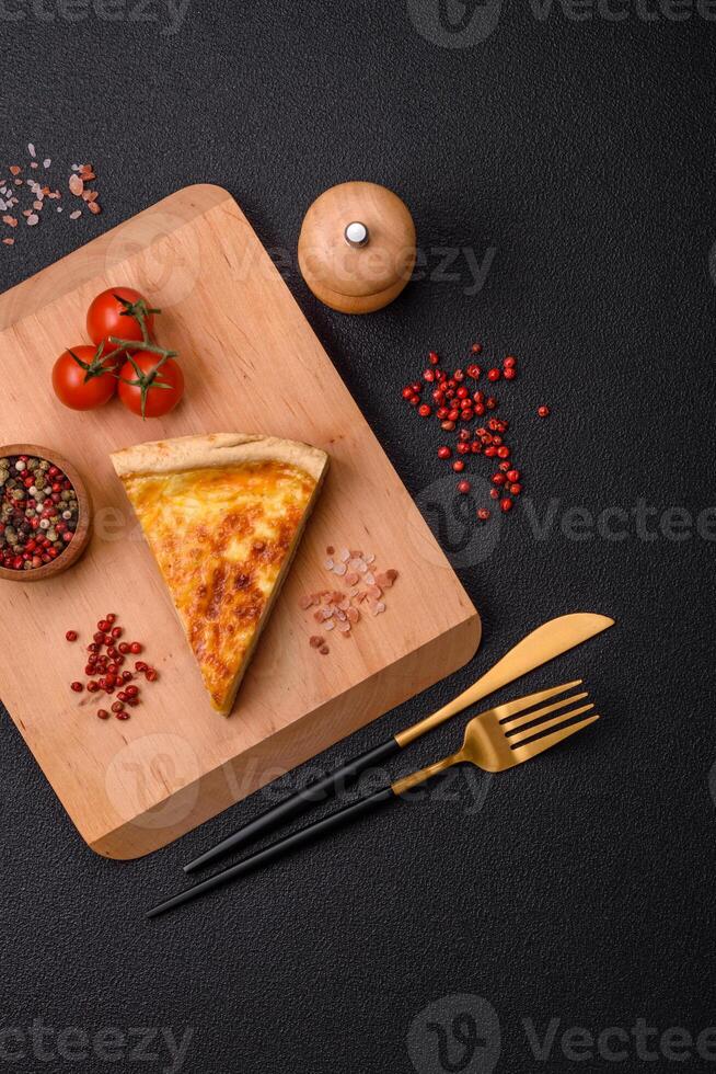 Delicious crispy quiche cut into slices with cheese, broccoli, tomatoes photo