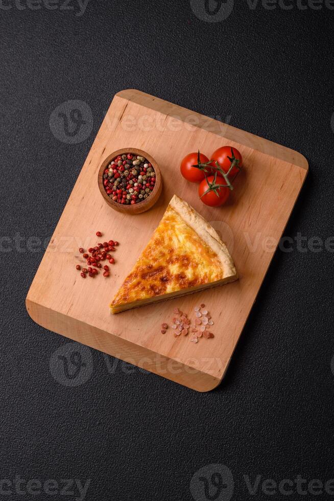 Delicious crispy quiche cut into slices with cheese, broccoli, tomatoes photo