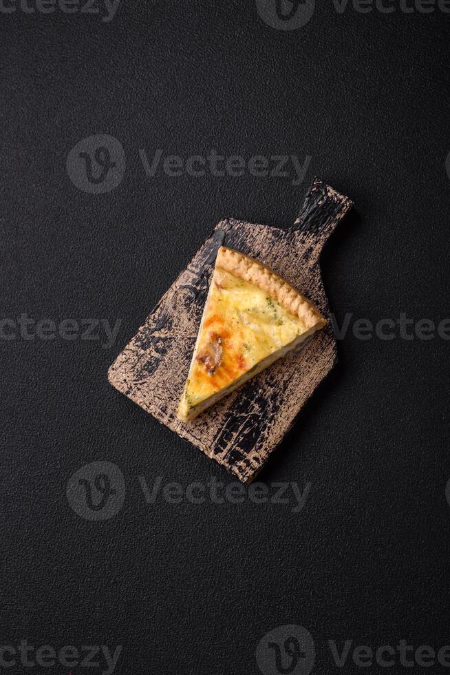 Delicious crispy quiche cut into slices with cheese, broccoli, tomatoes photo
