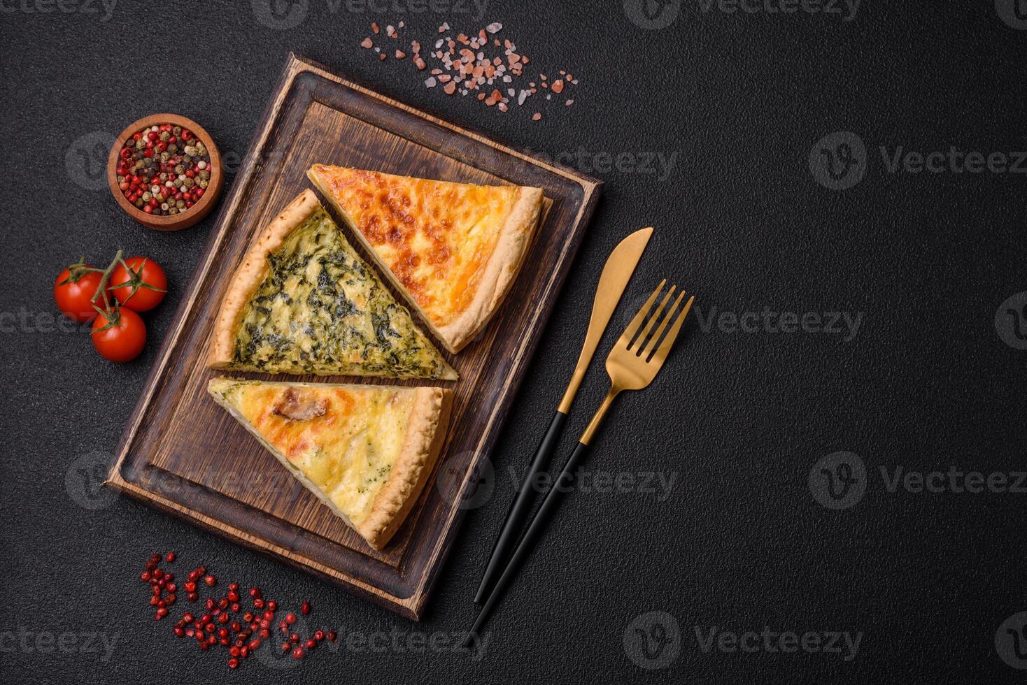 Delicious crispy quiche cut into slices with cheese, broccoli, tomatoes photo