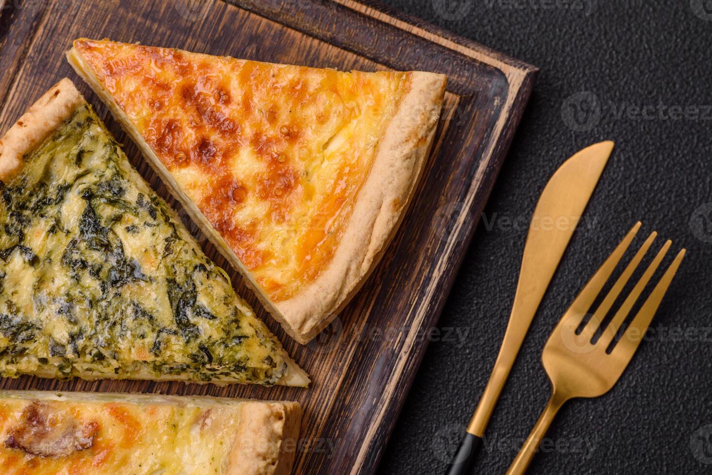 Delicious crispy quiche cut into slices with cheese, broccoli, tomatoes photo