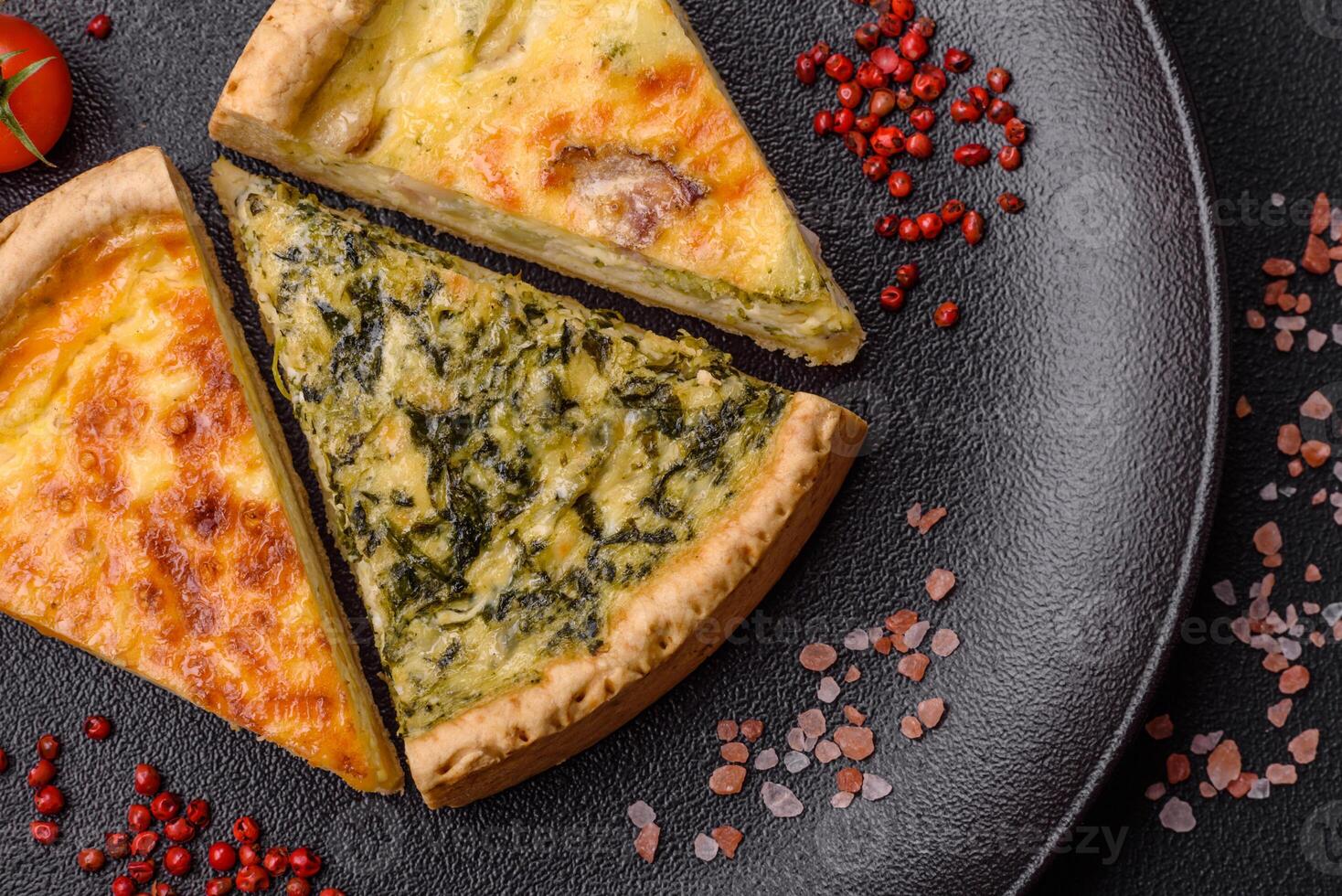 Delicious crispy quiche cut into slices with cheese, broccoli, tomatoes photo
