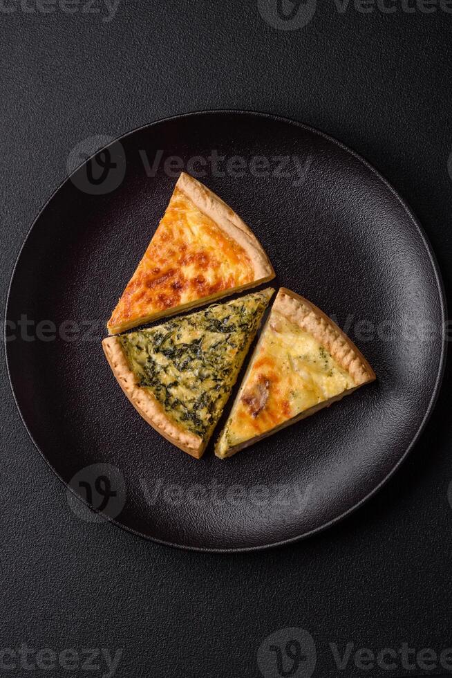 Delicious crispy quiche cut into slices with cheese, broccoli, tomatoes photo