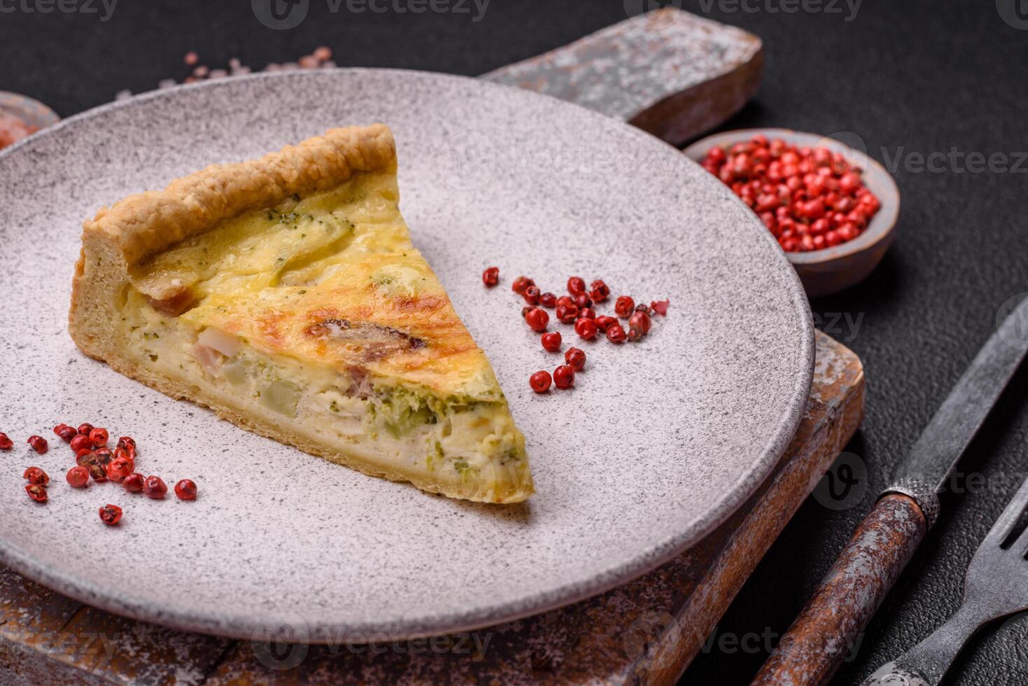 Delicious crispy quiche cut into slices with cheese, broccoli, tomatoes photo