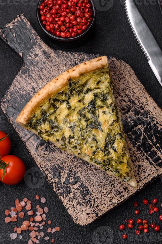 Delicious crispy quiche cut into slices with cheese, broccoli, tomatoes photo