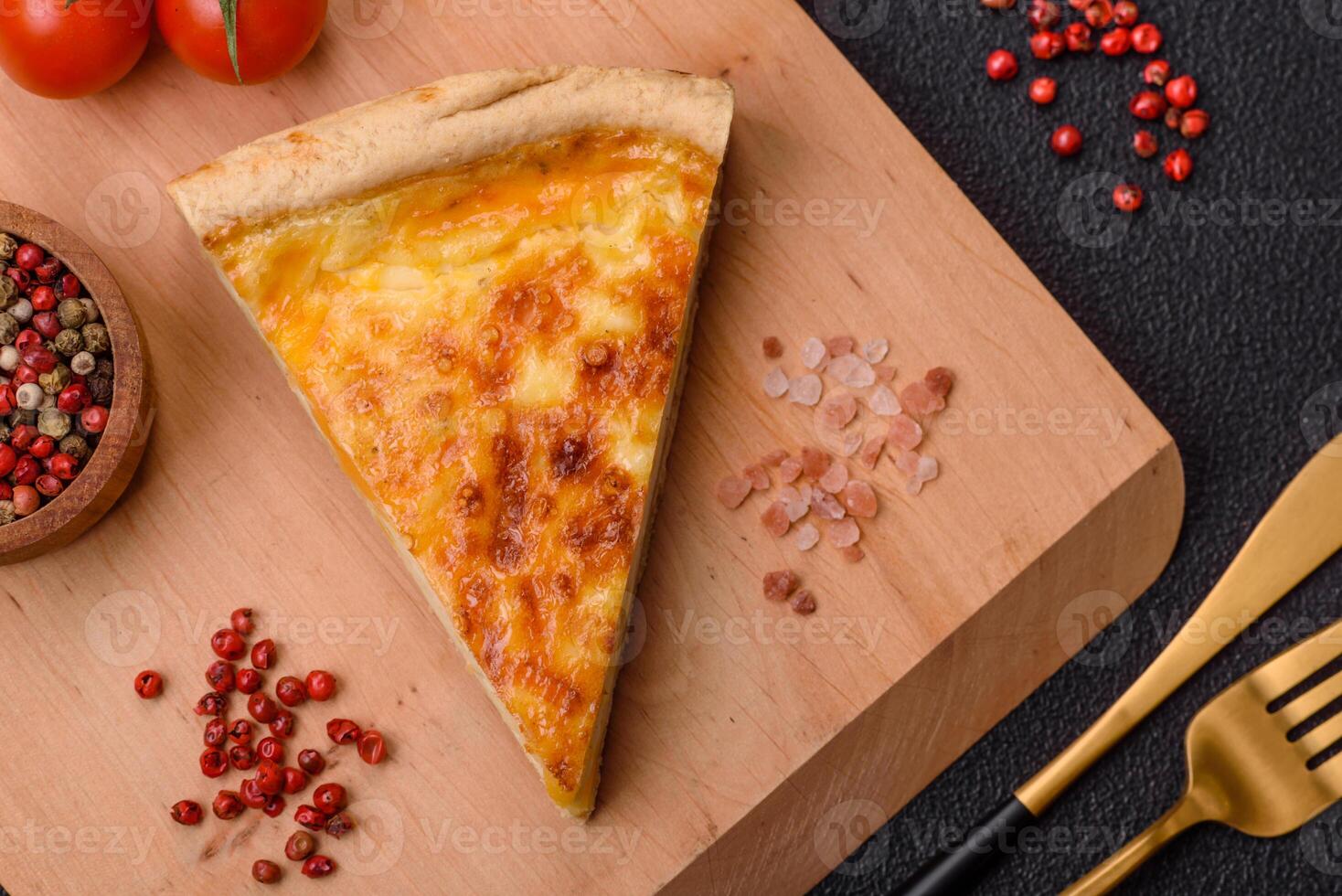 Delicious crispy quiche cut into slices with cheese, broccoli, tomatoes photo