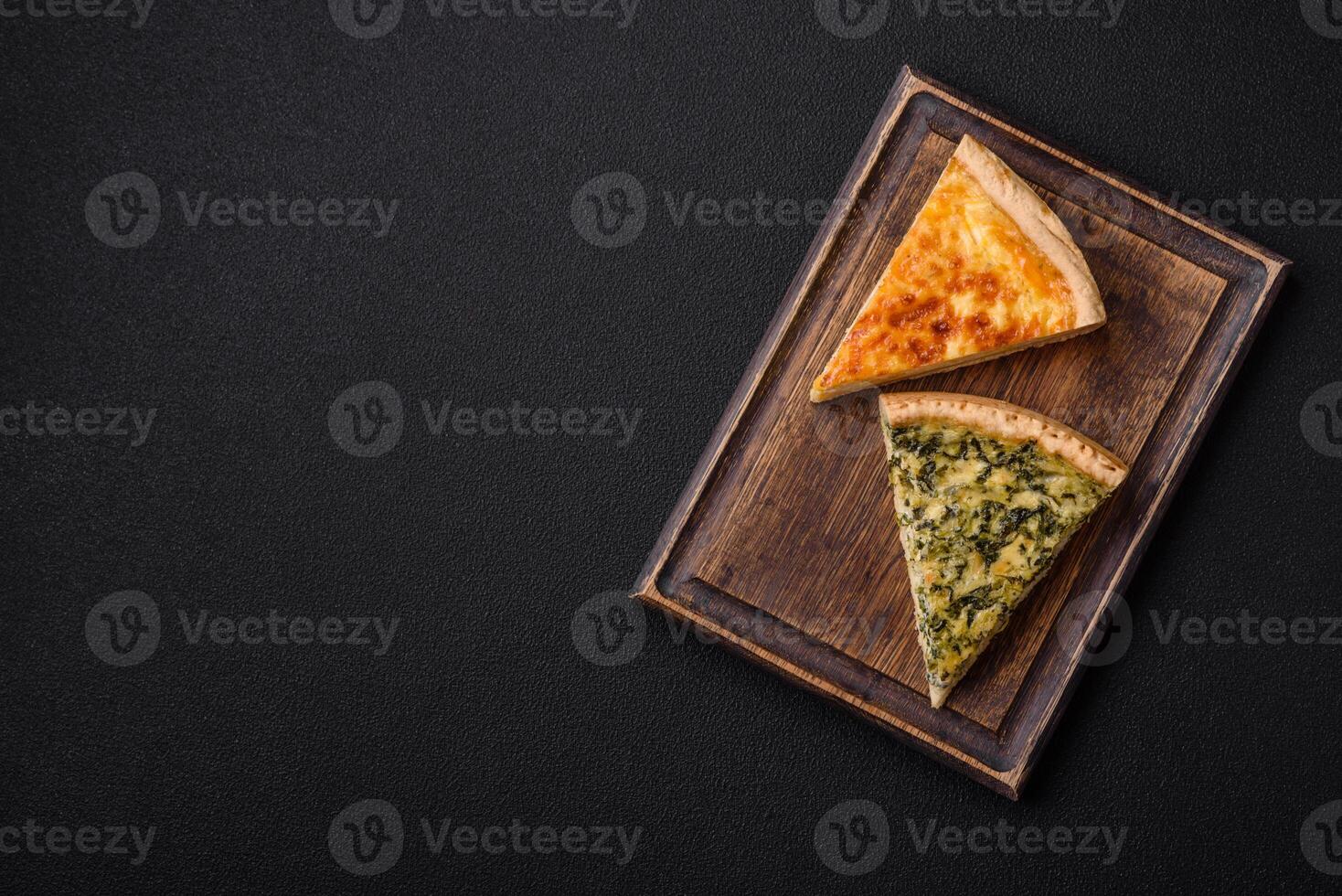 Delicious crispy quiche cut into slices with cheese, broccoli, tomatoes photo