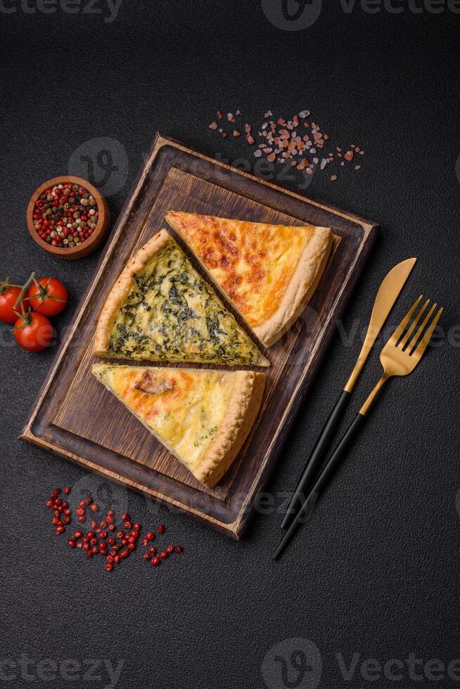 Delicious crispy quiche cut into slices with cheese, broccoli, tomatoes photo