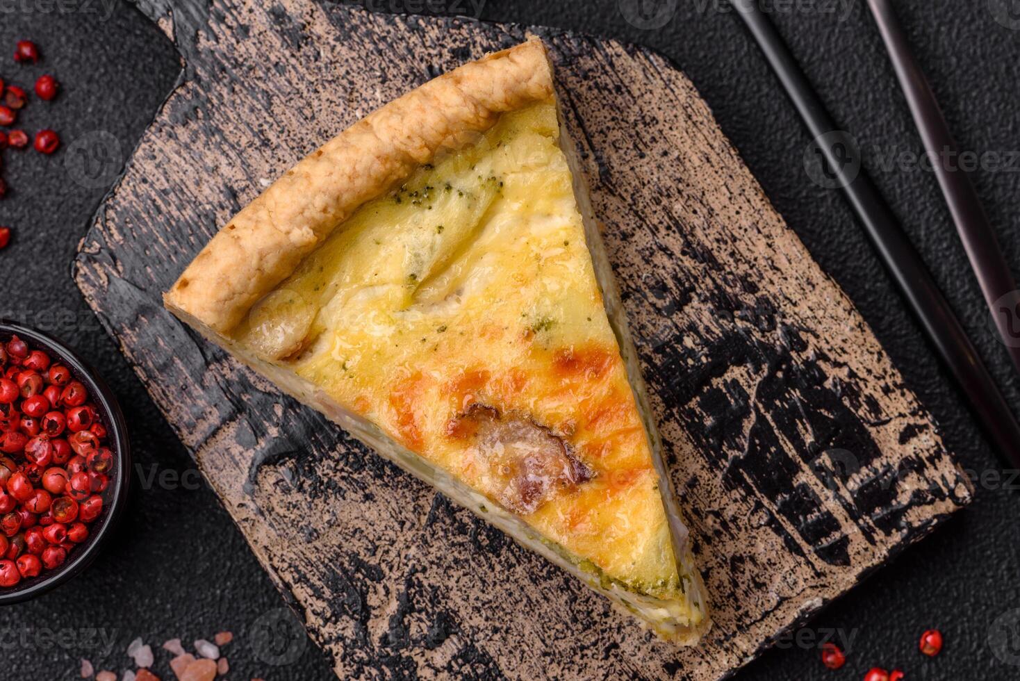 Delicious crispy quiche cut into slices with cheese, broccoli, tomatoes photo
