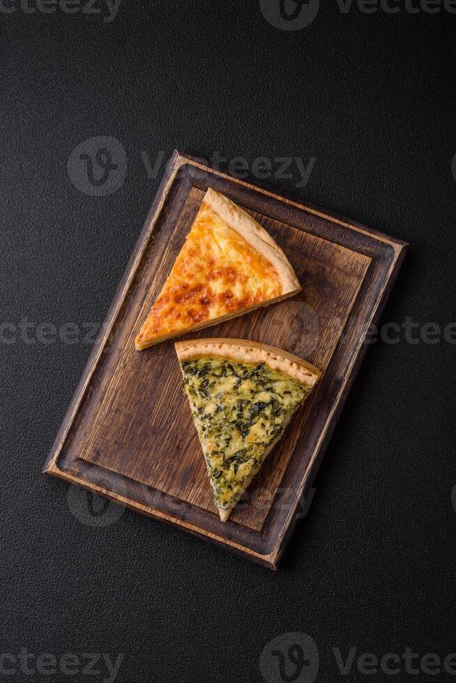 Delicious crispy quiche cut into slices with cheese, broccoli, tomatoes photo