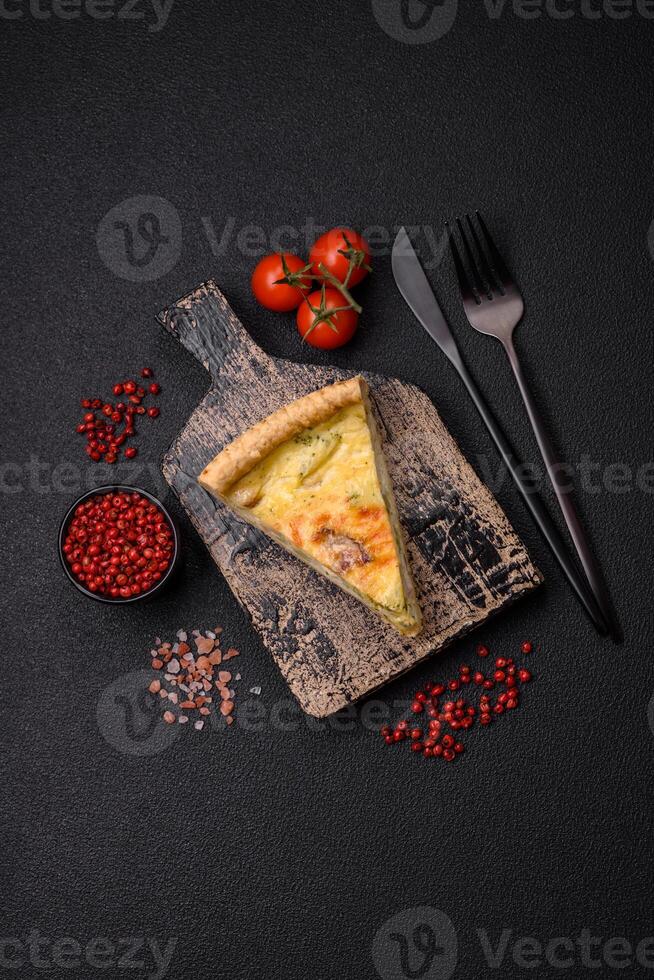 Delicious crispy quiche cut into slices with cheese, broccoli, tomatoes photo