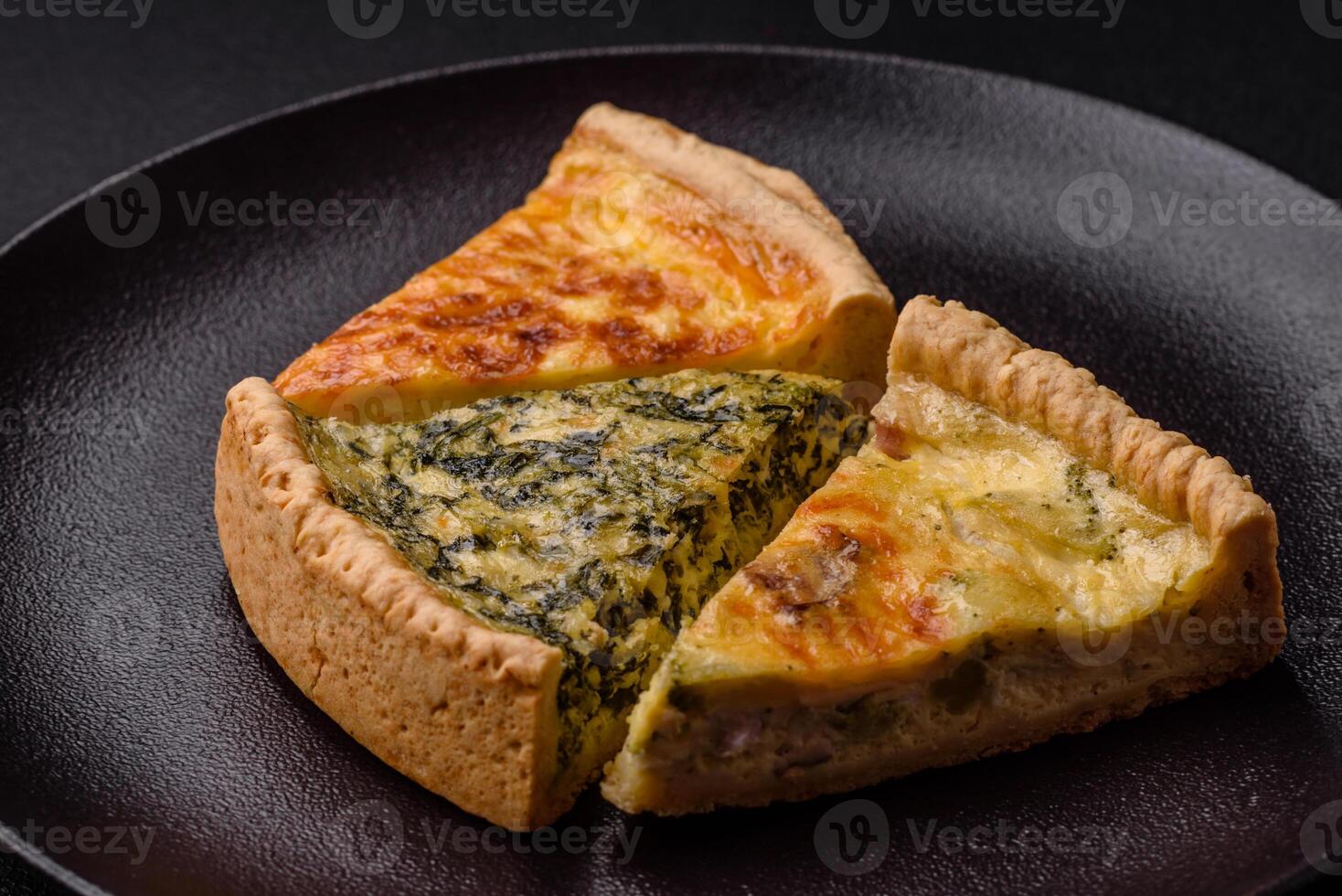 Delicious crispy quiche cut into slices with cheese, broccoli, tomatoes photo