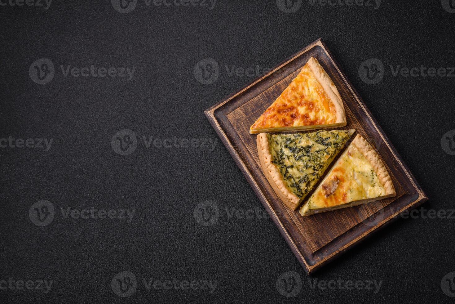 Delicious crispy quiche cut into slices with cheese, broccoli, tomatoes photo