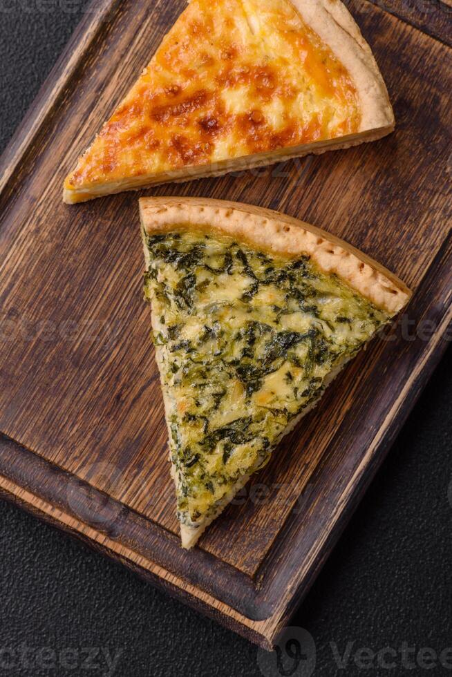 Delicious crispy quiche cut into slices with cheese, broccoli, tomatoes photo