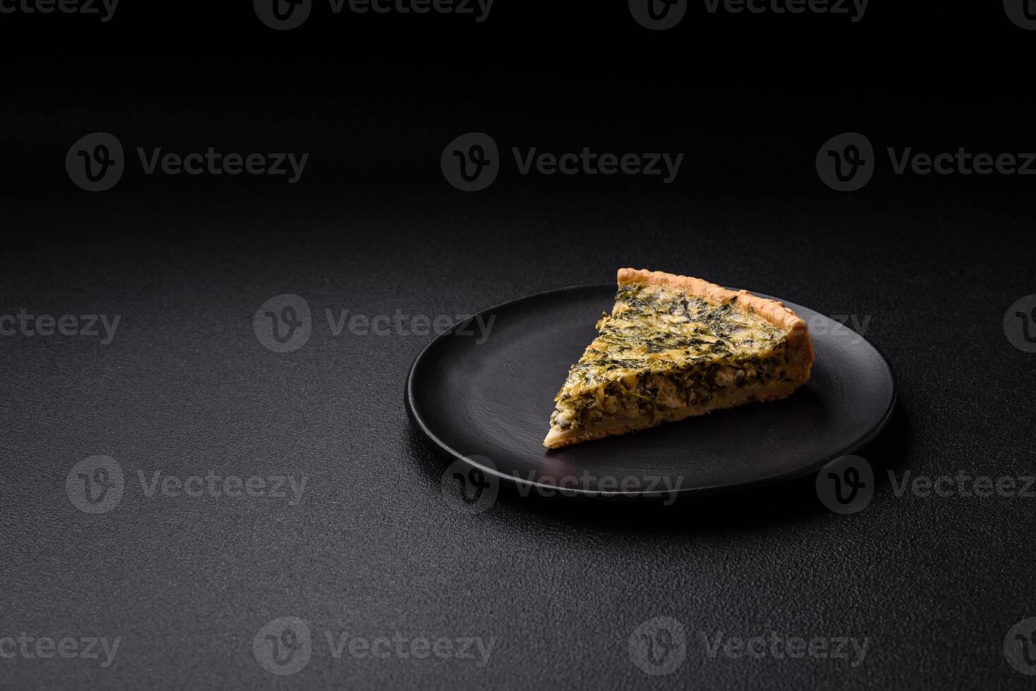 Delicious crispy quiche cut into slices with cheese, broccoli, tomatoes photo