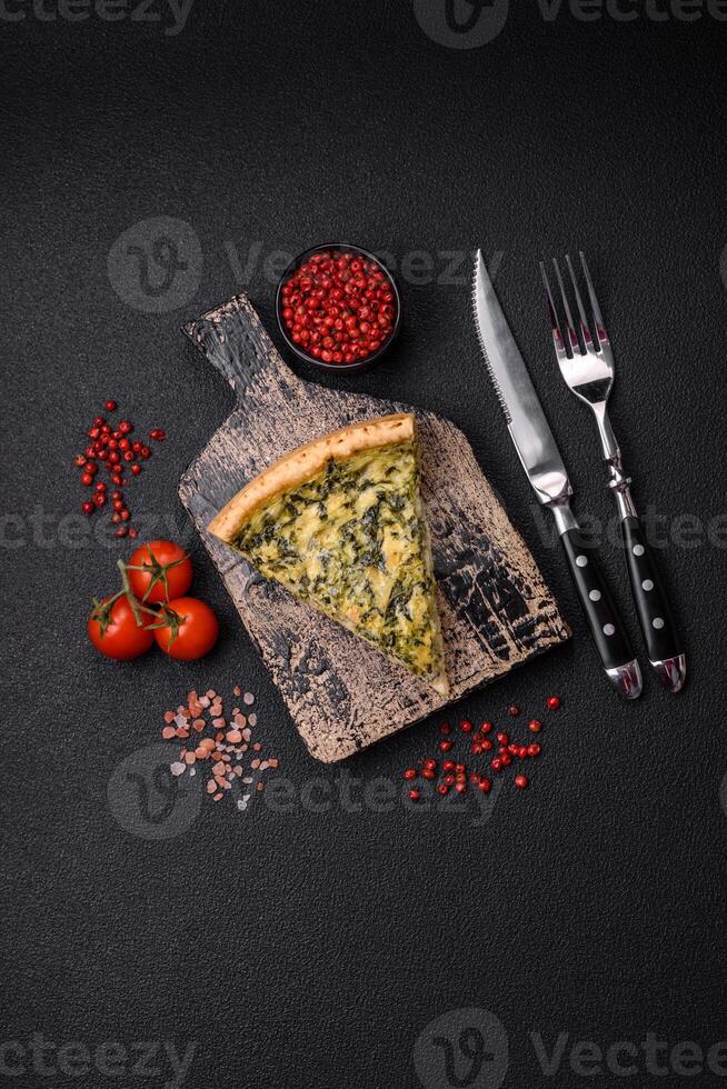 Delicious crispy quiche cut into slices with cheese, broccoli, tomatoes photo
