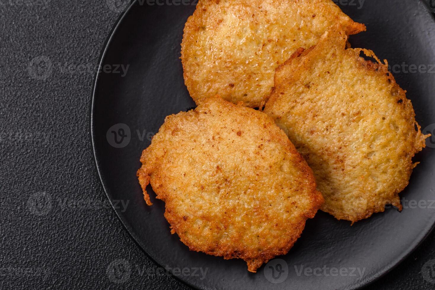Delicious crispy pancakes made from potatoes, meat, carrots, onions photo