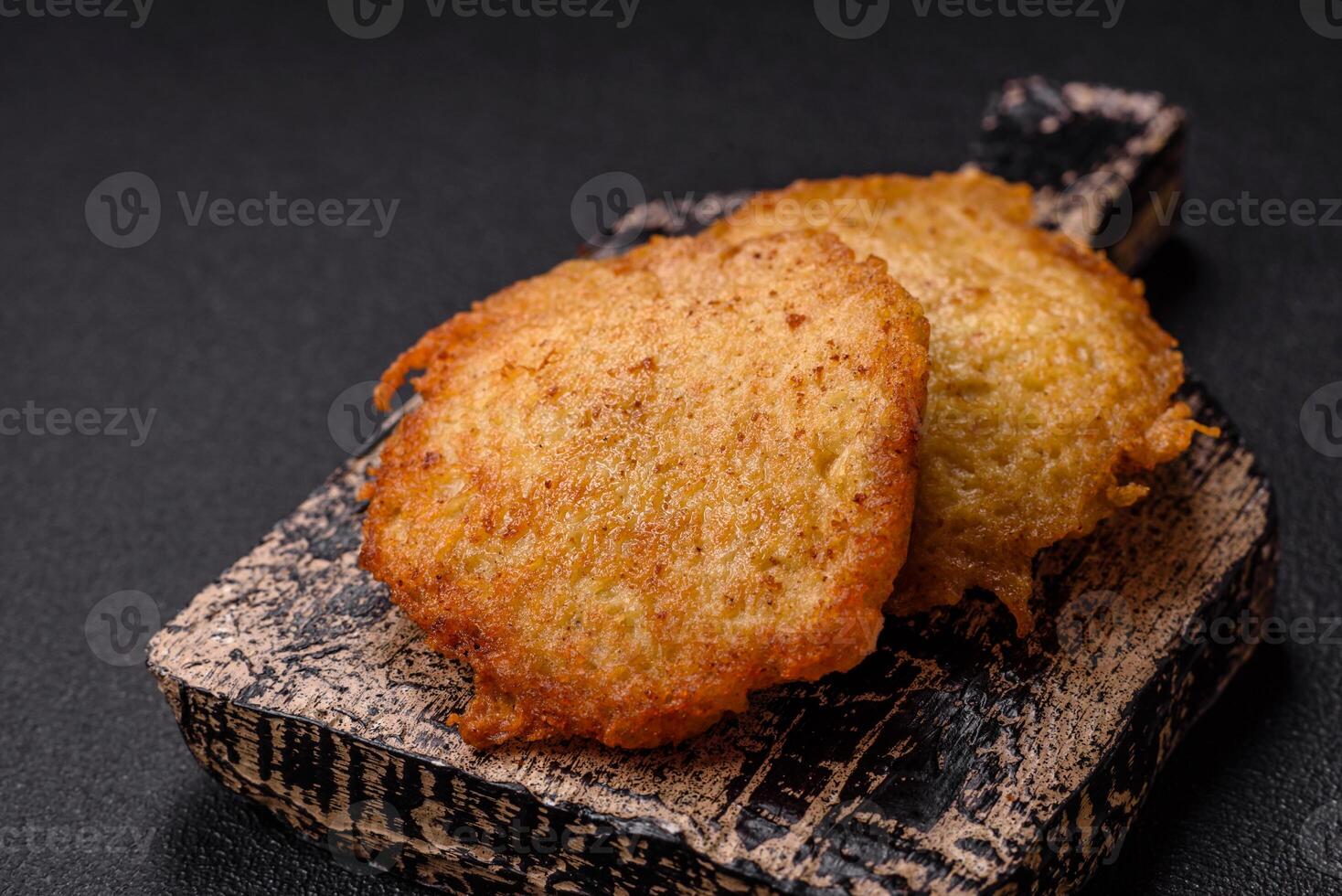 Delicious crispy pancakes made from potatoes, meat, carrots, onions photo