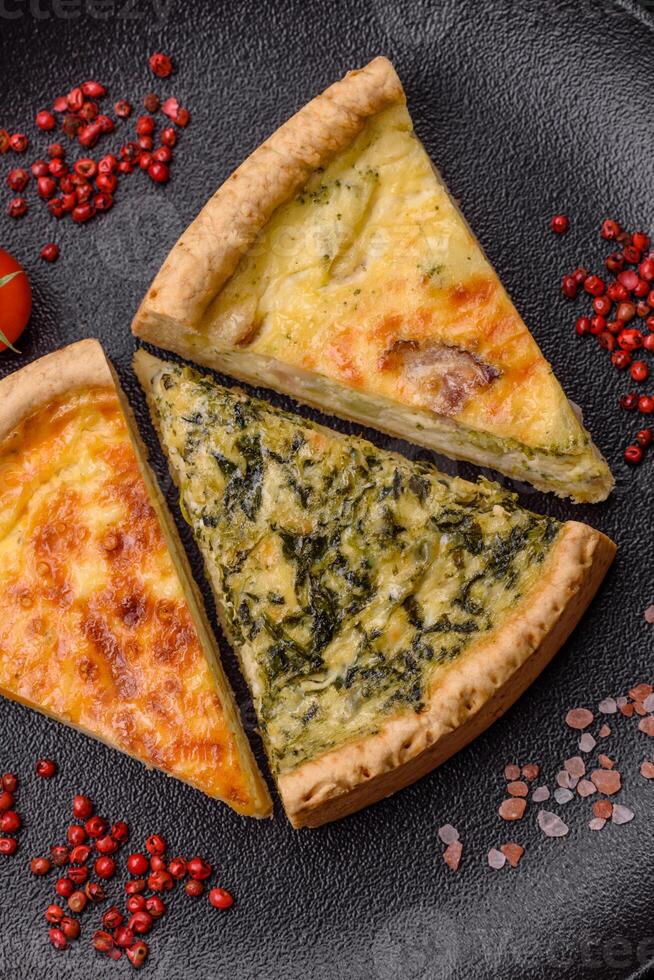 Delicious crispy quiche cut into slices with cheese, broccoli, tomatoes photo