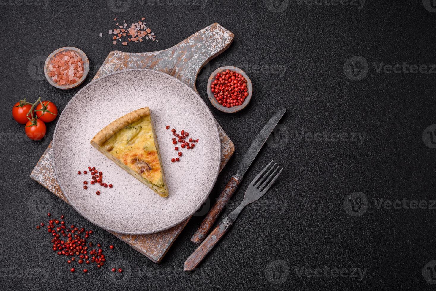 Delicious crispy quiche cut into slices with cheese, broccoli, tomatoes photo