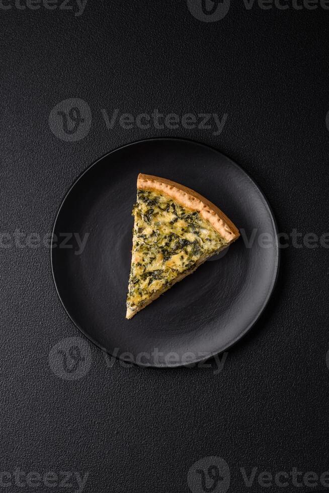 Delicious crispy quiche cut into slices with cheese, broccoli, tomatoes photo