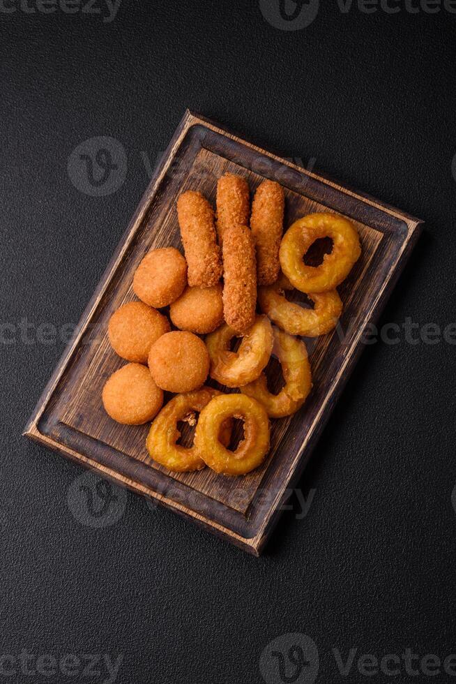 Delicious nuggets, rings and balls of mozzarella and parmesan cheese photo