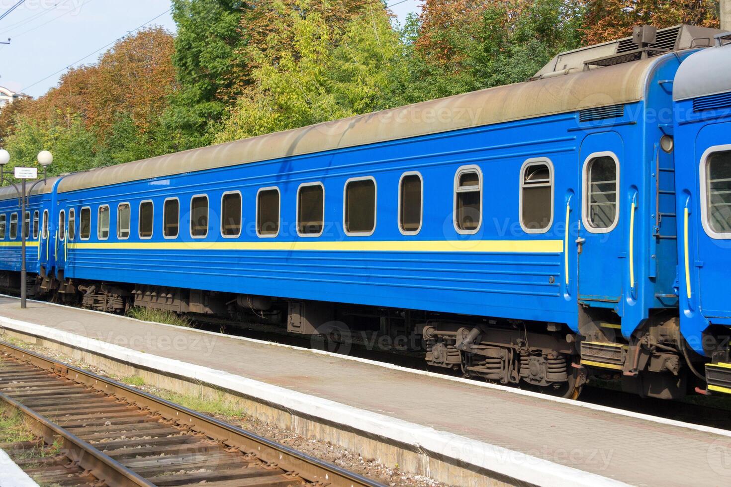 Close up of coming old blue train at the railway station photo