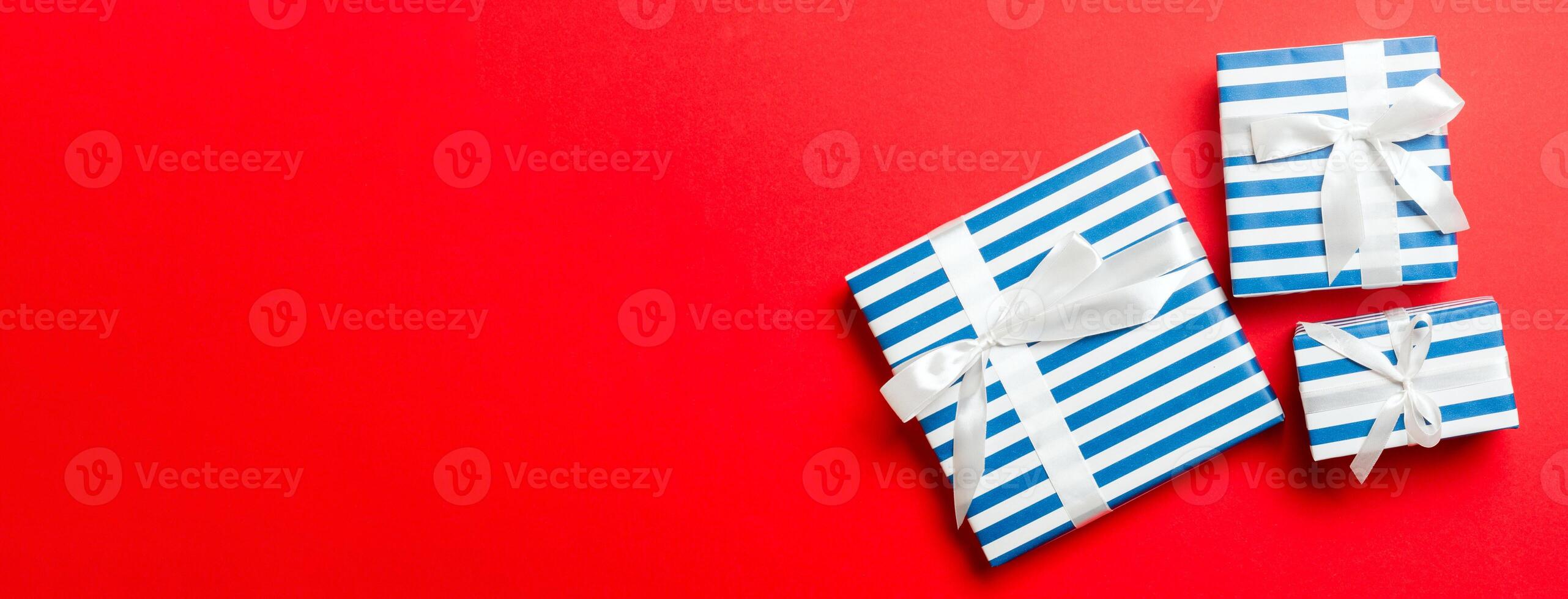 Top view Christmas present box with White bow on red background photo