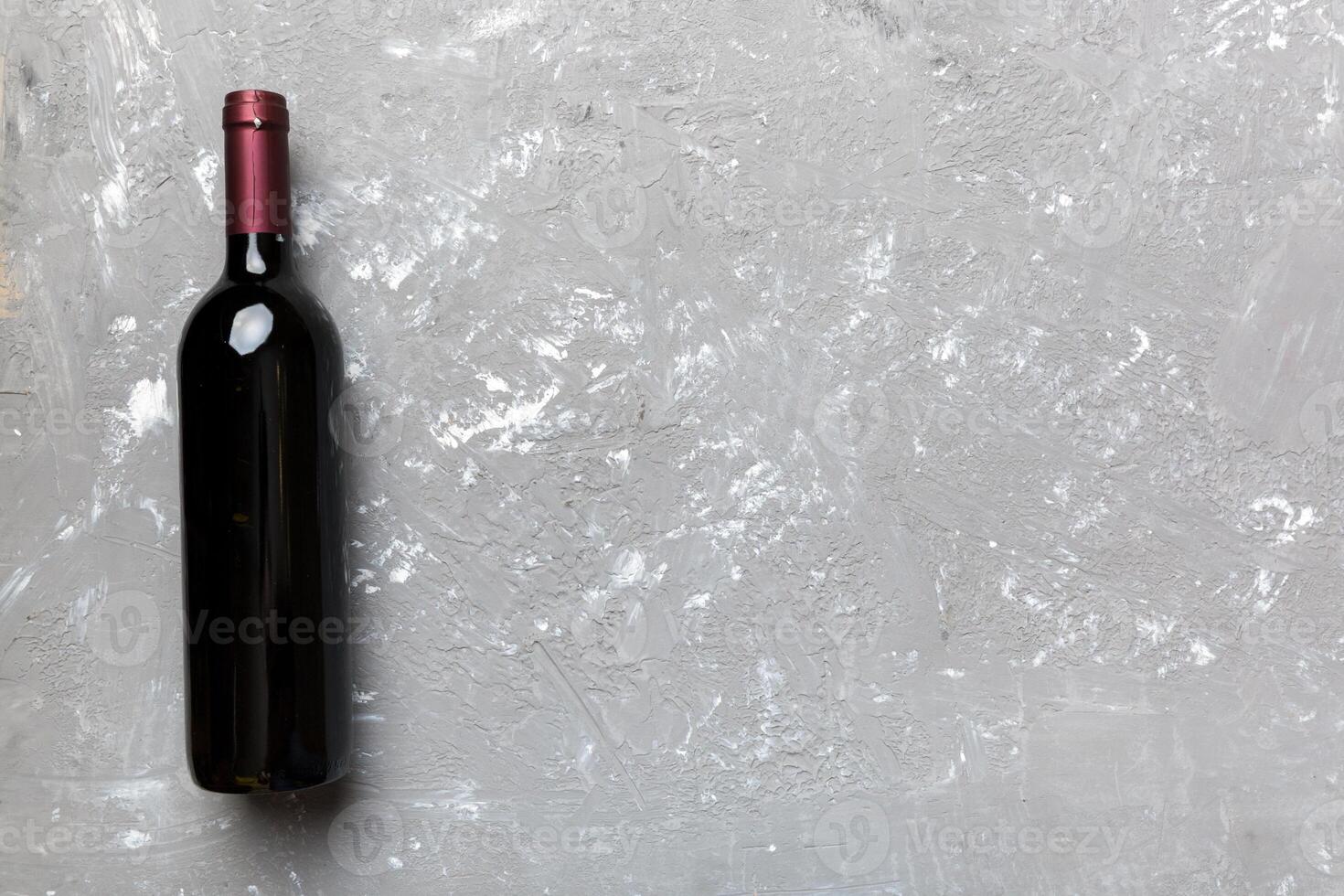 One Bottle of red wine on colored table. Flat lay, top view wth copy space photo