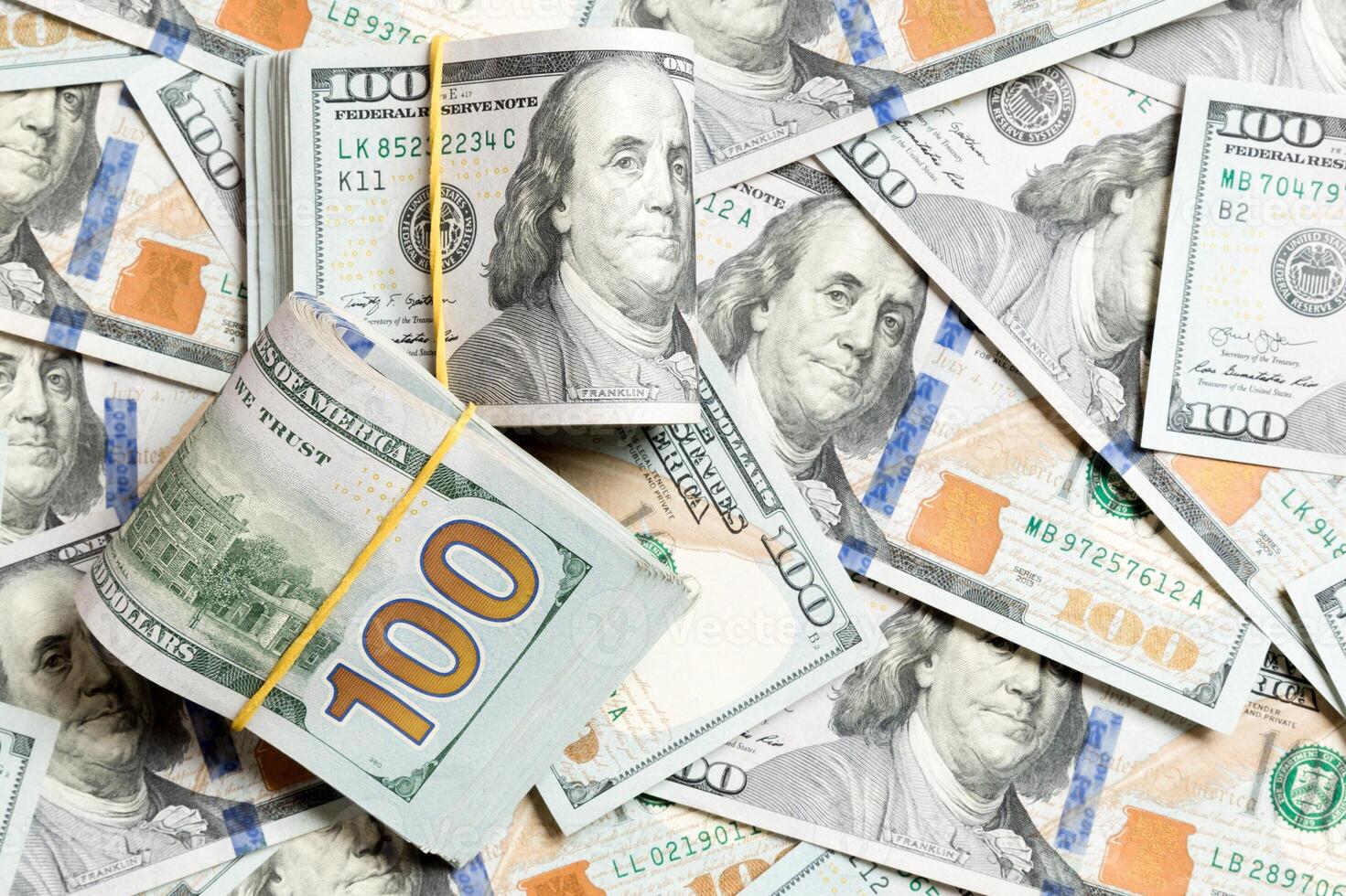 Many Stack of 100 dollar bills on dollars background top wiev with copy space photo
