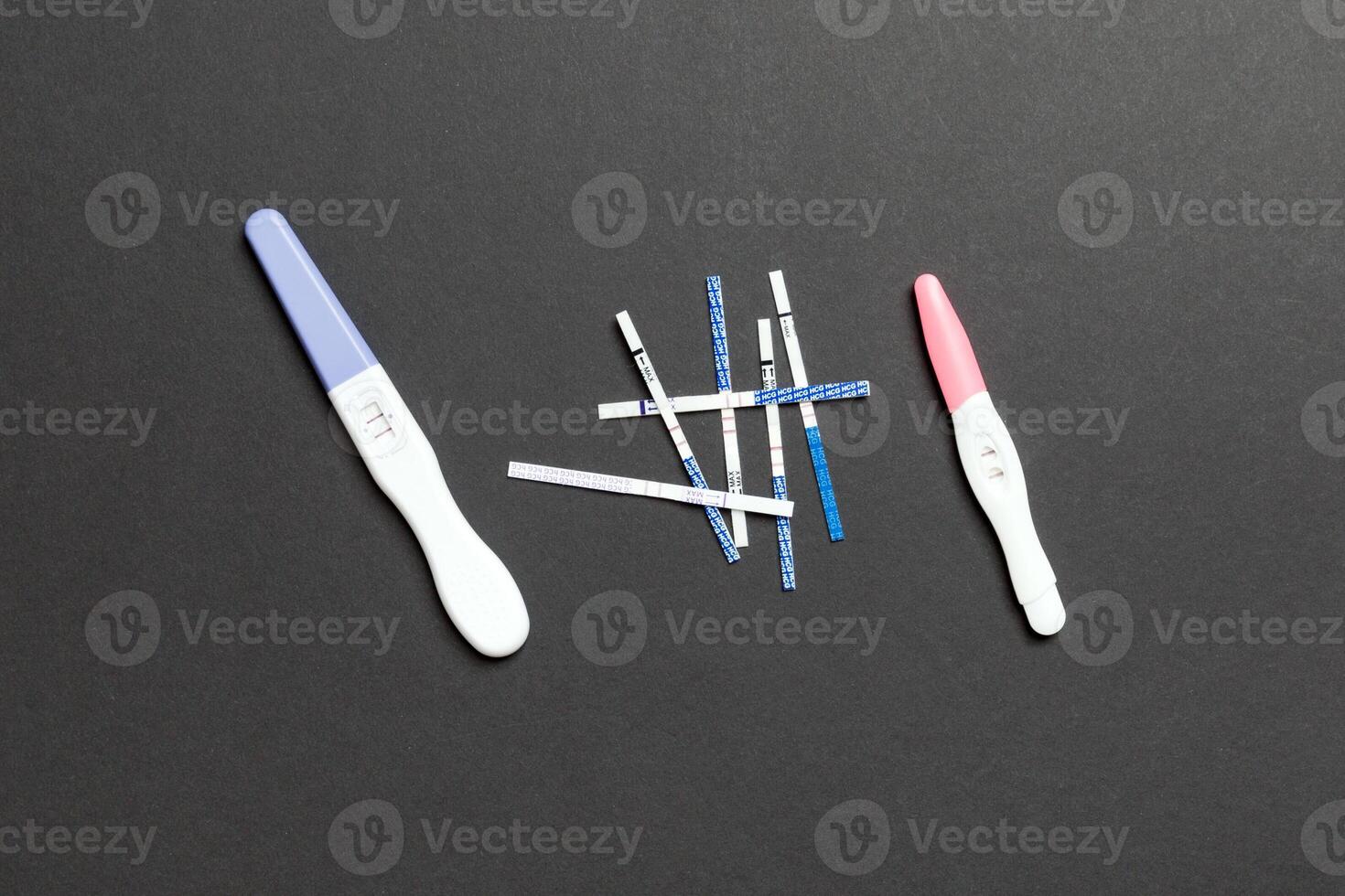 Colored Pregnancy test on colored background, top view with copy space photo