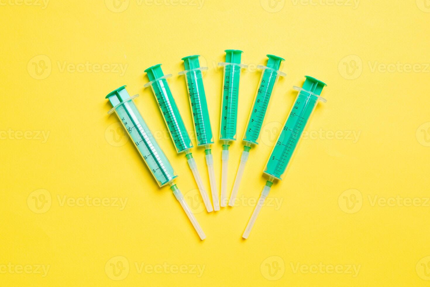 Top view of different syringes for injection on colorful background. Medical equipment concept with copy space photo