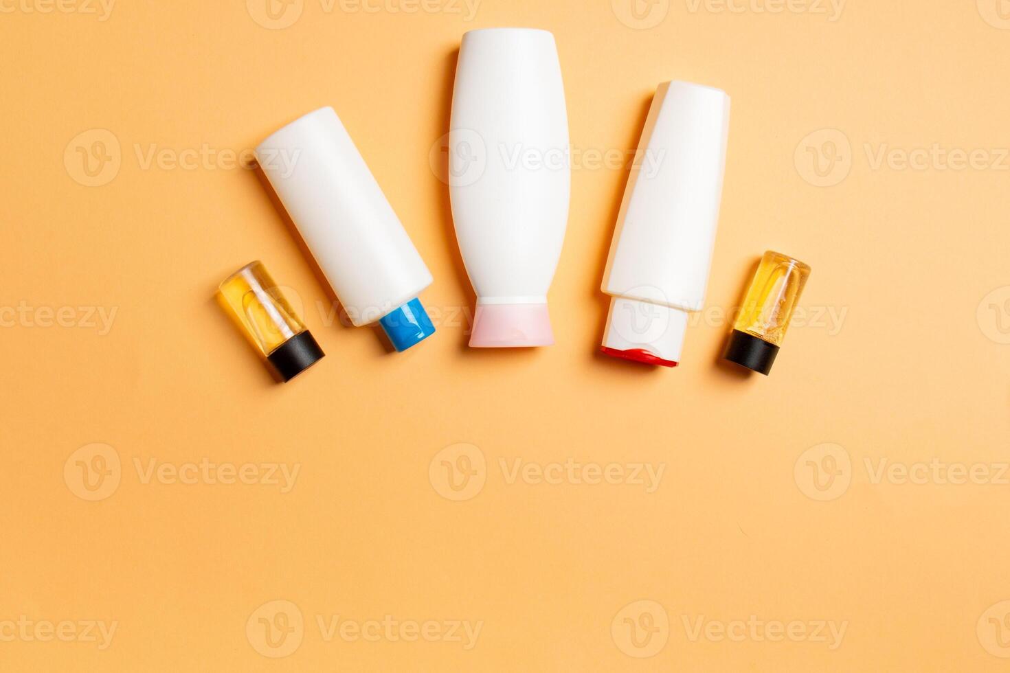 Cosmetics SPA branding mock-up, top view with copy space. set of tubes and jars of cream flat lay on colored background photo