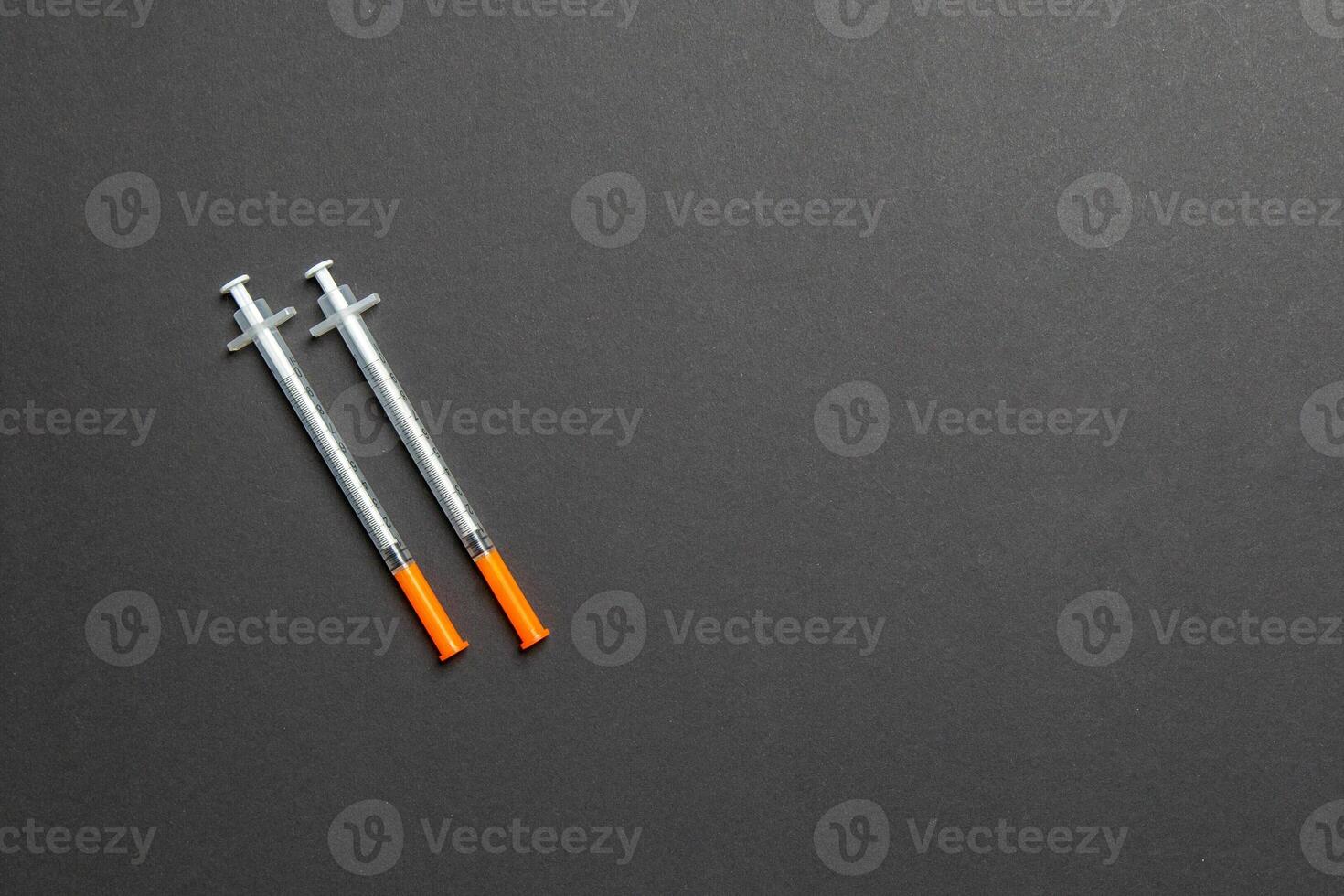 Top view of two insulin syringe at colorful background with copy space. High level of glucose concept photo