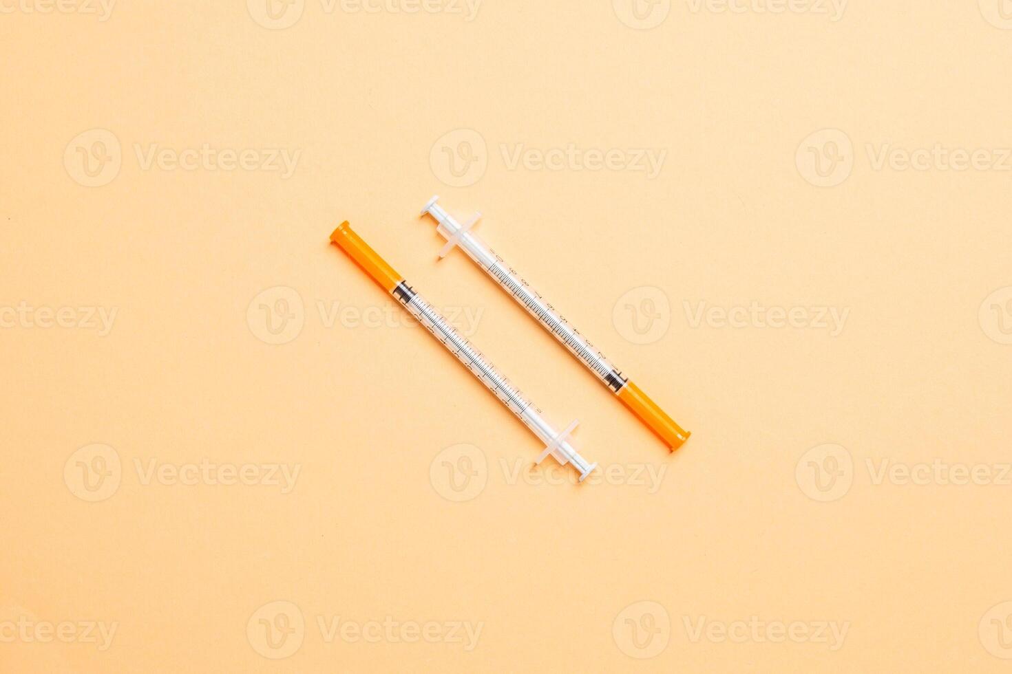 Top view of insulin syringes ready for injection on colorful background. Diabetic concept with copy space photo