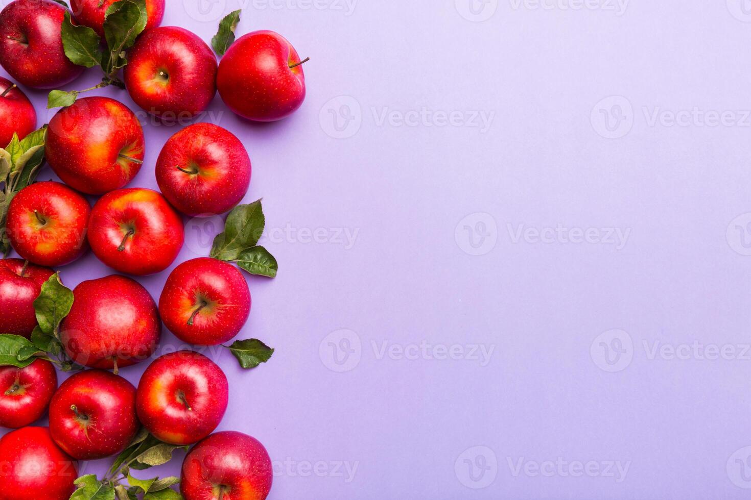 Many red apples on colored background, top view. Autumn pattern with fresh apple above view with copy space for design or text photo