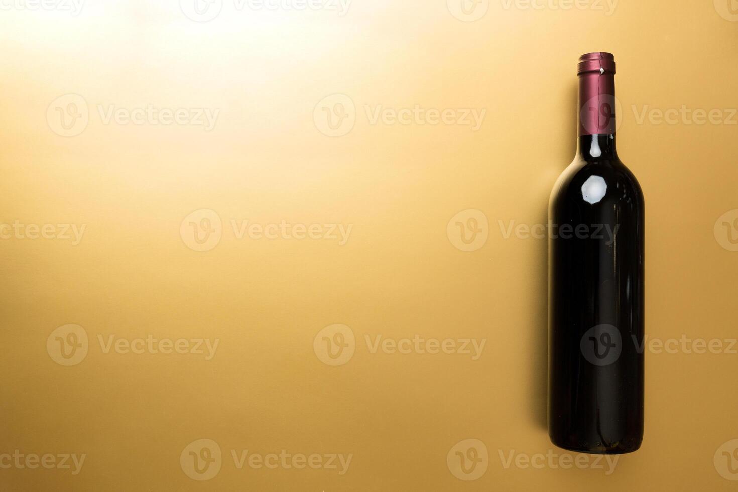 One Bottle of red wine on colored table. Flat lay, top view wth copy space photo