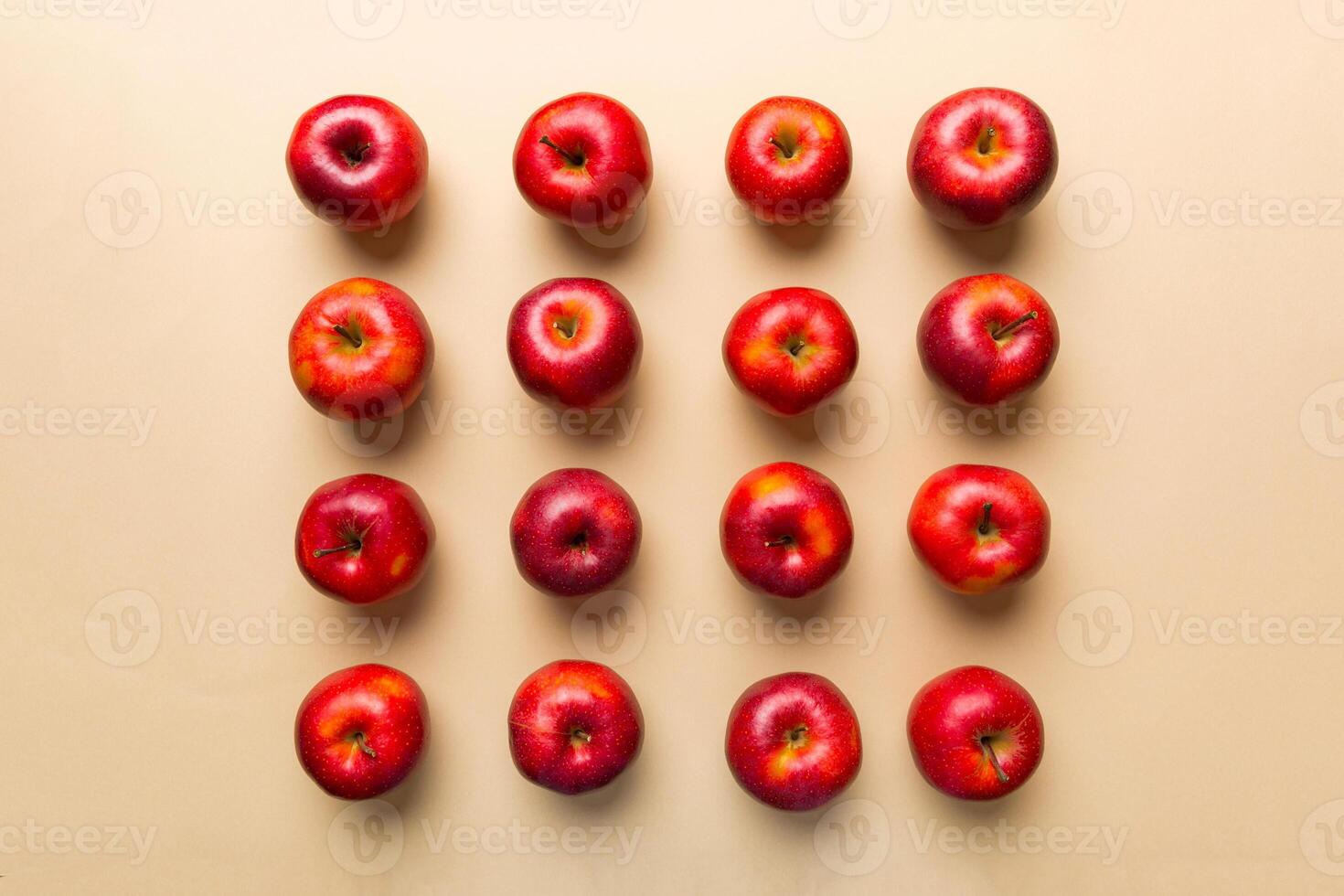 Many red apples on colored background, top view. Autumn pattern with fresh apple above view photo
