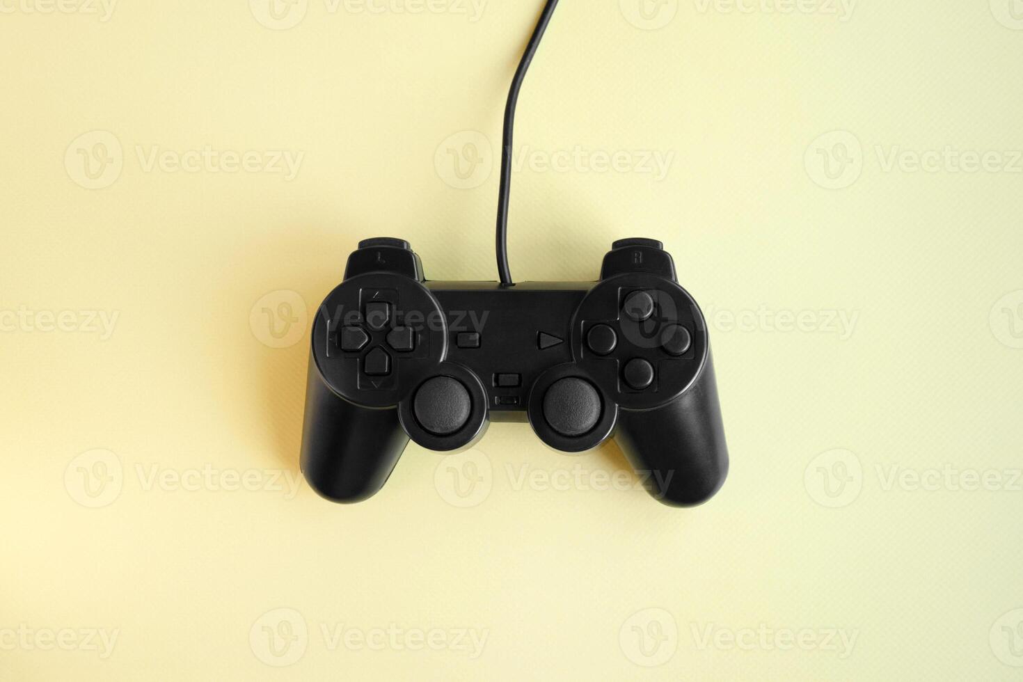 One joystick gaming controller on yellow background. photo