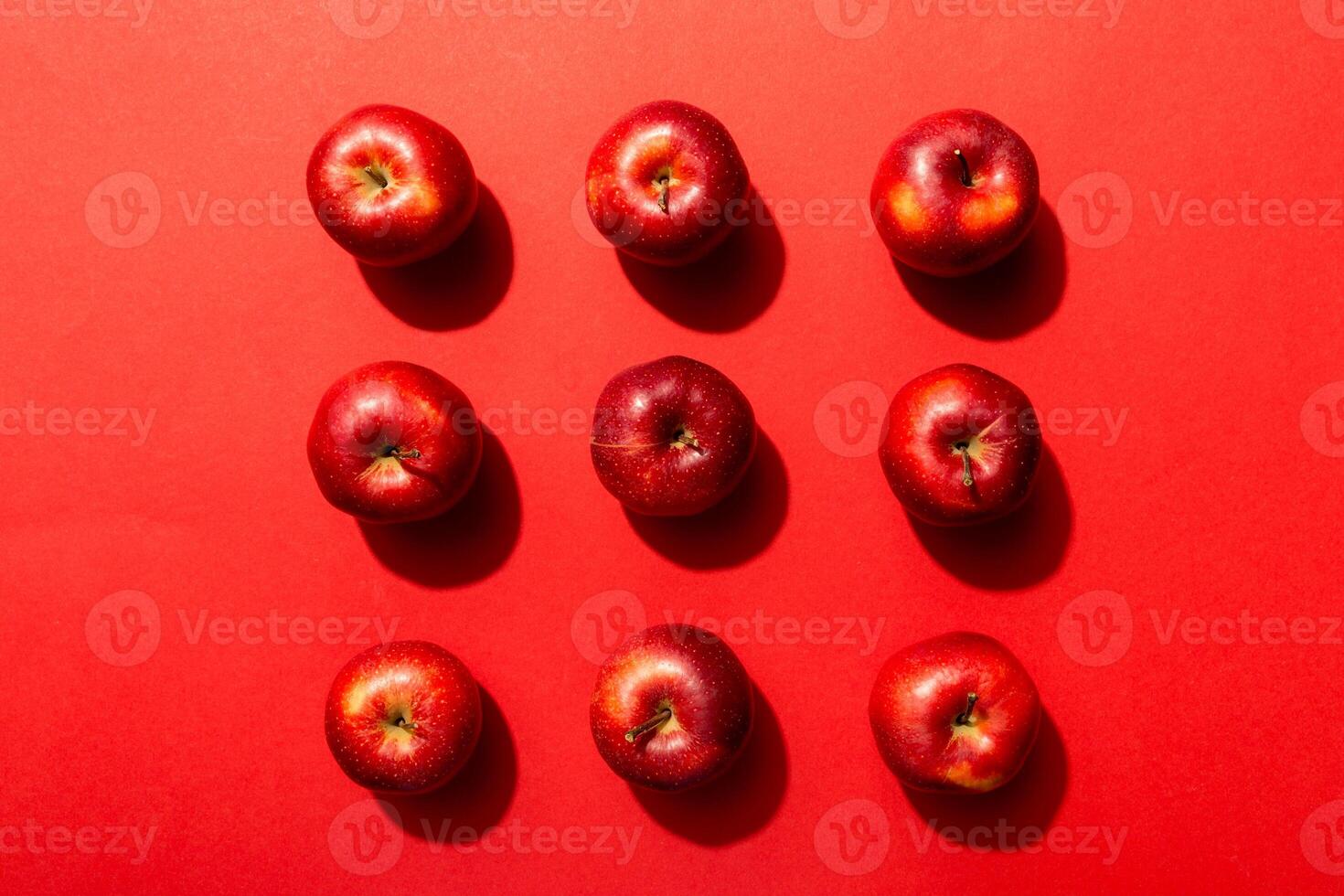 Many red apples on colored background, top view. Autumn pattern with fresh apple above view photo