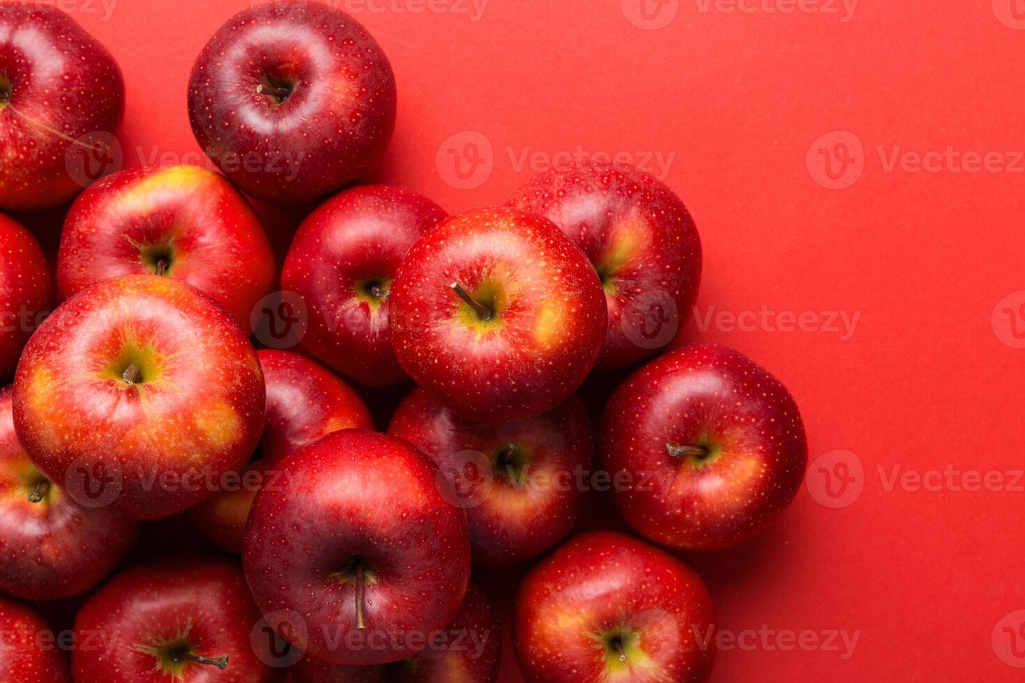 Many red apples on colored background, top view. Autumn pattern with fresh apple above view with copy space for design or text photo